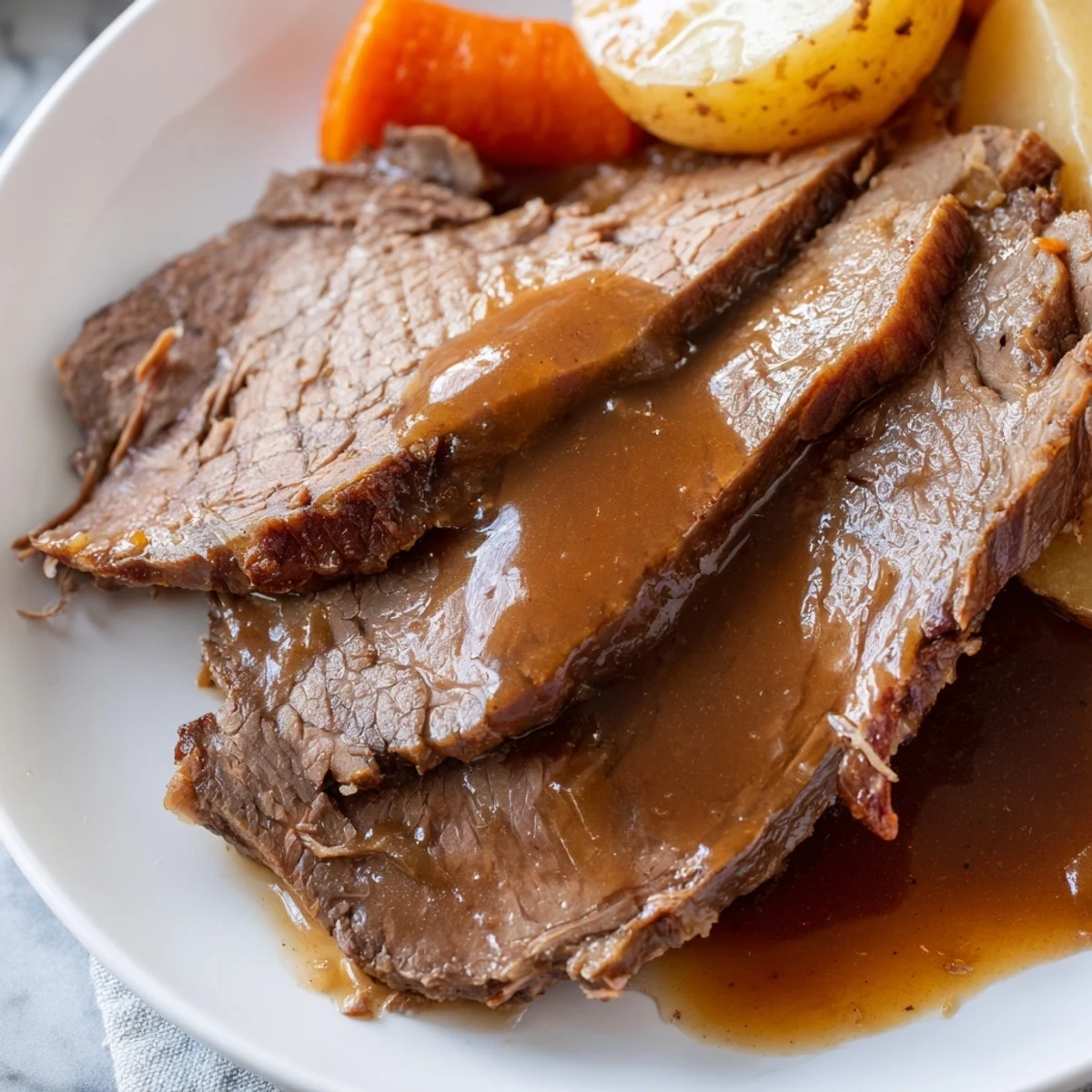 Golden-brown Slow Cooker Roast Beef slice over creamy mashed potatoes, garnished with fresh thyme for a comforting dinner.