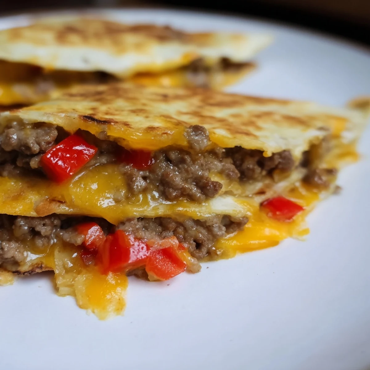 Golden-brown flour tortillas filled with seasoned beef and cheese, served alongside vibrant fresh salsa and guacamole.