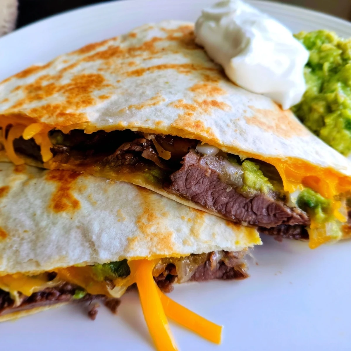 Melted cheese and savory beef filling peek from crispy flour tortilla wedges.