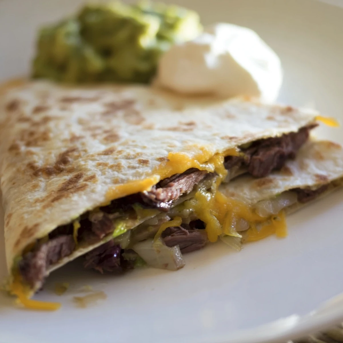 Fresh salsa and creamy guacamole accompany golden Tex-Mex beef quesadillas for dipping.