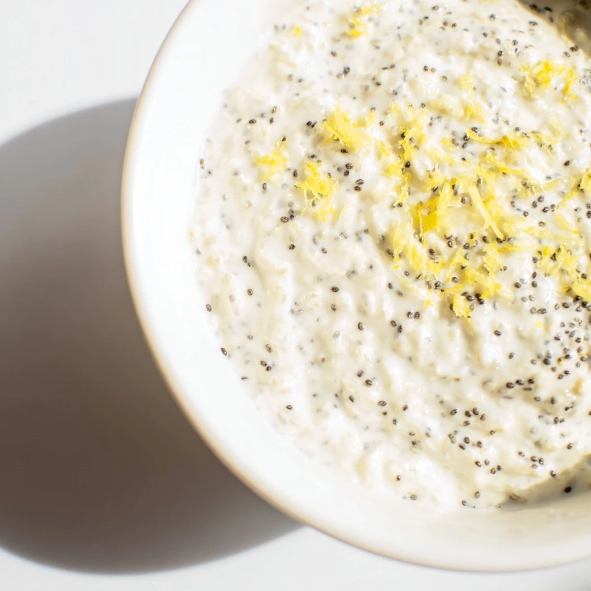 Close-up of the Vegan Lemon Poppy Seed Overnight Oats showing creamy texture, bright lemon zest, and crunchy poppy seeds.