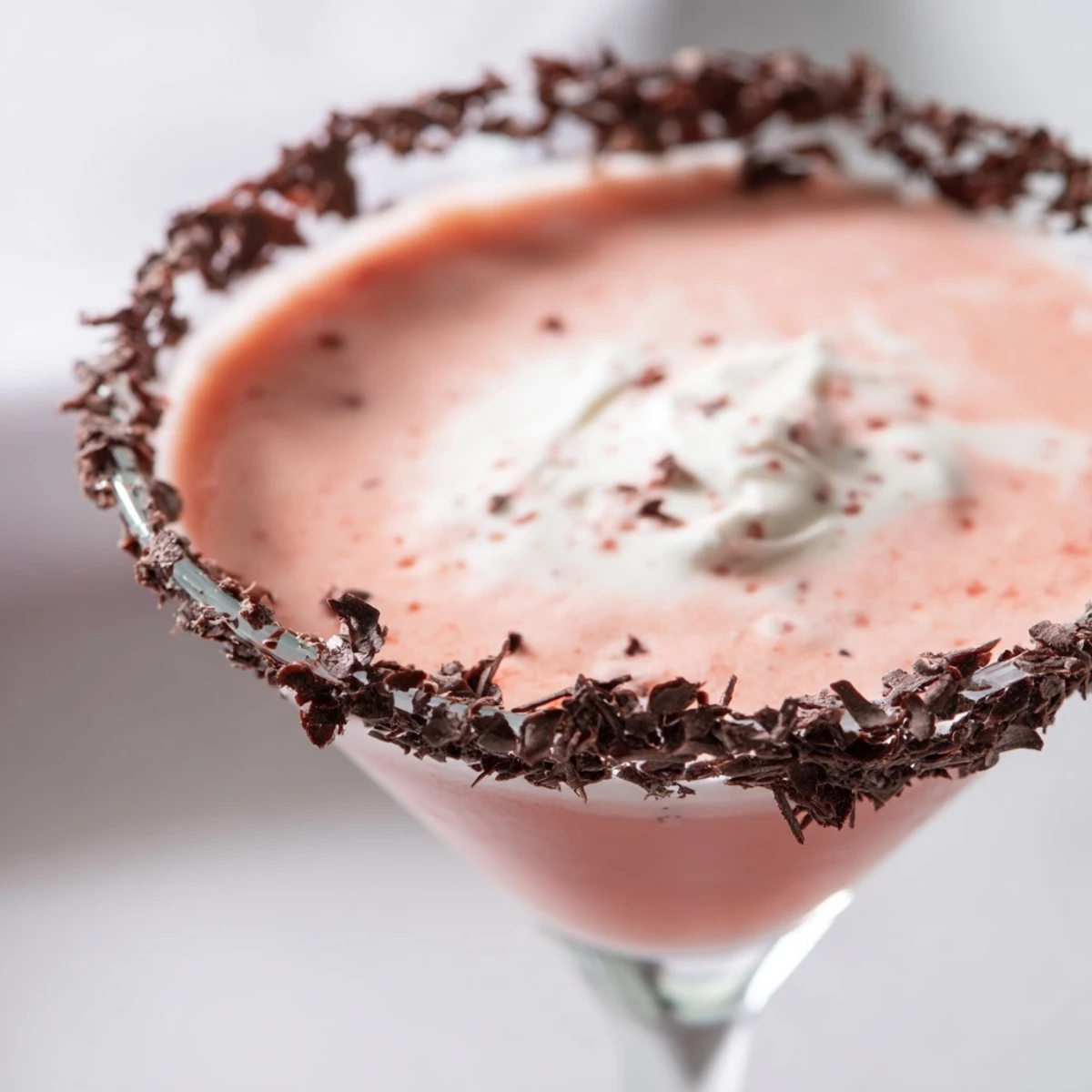 The Decadent Red Velvet Martini shows its rich, creamy red texture in a martini glass, ready for a festive dessert cocktail serving.