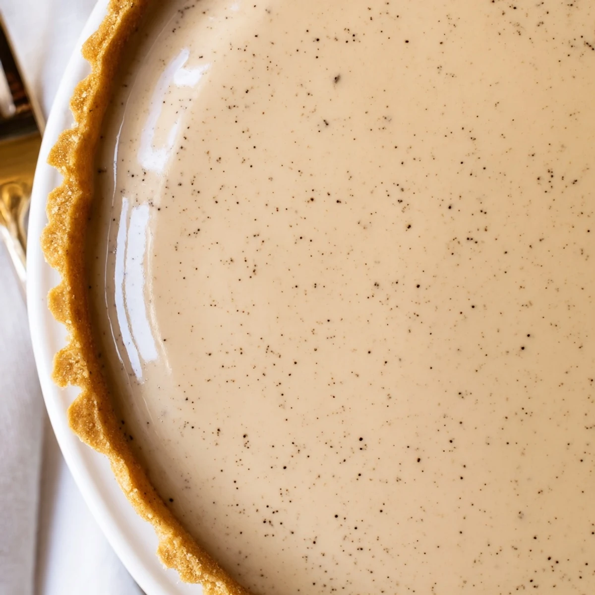 Slice of vanilla bean pastry cream tart with smooth custard and fresh berry topping