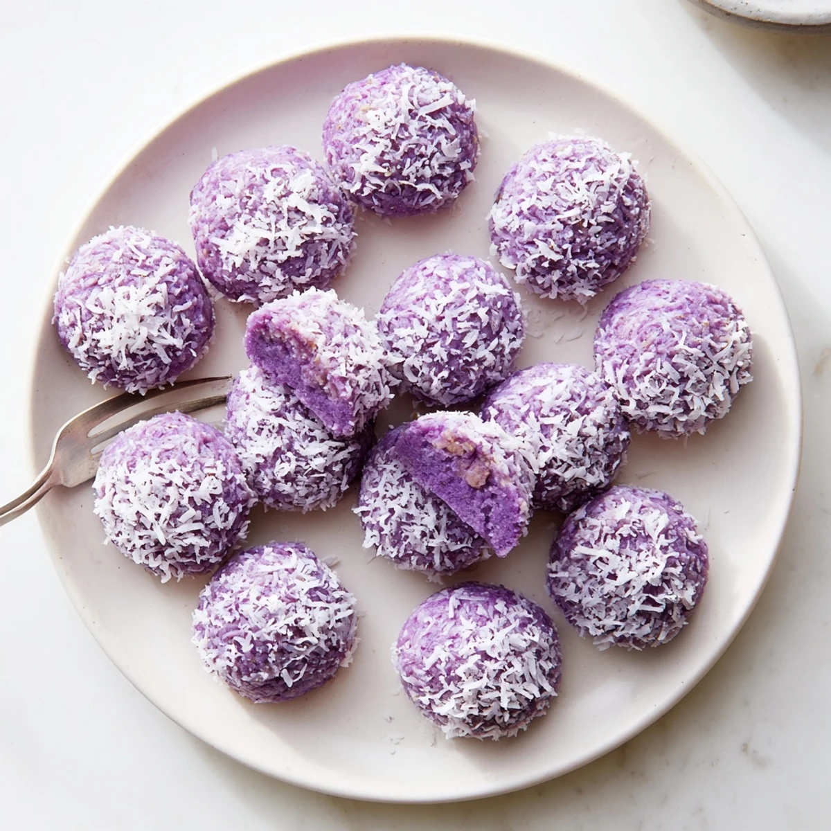 Golden Coconut Ube Besito Cookies cooling on wire rack with purple swirls visible throughout