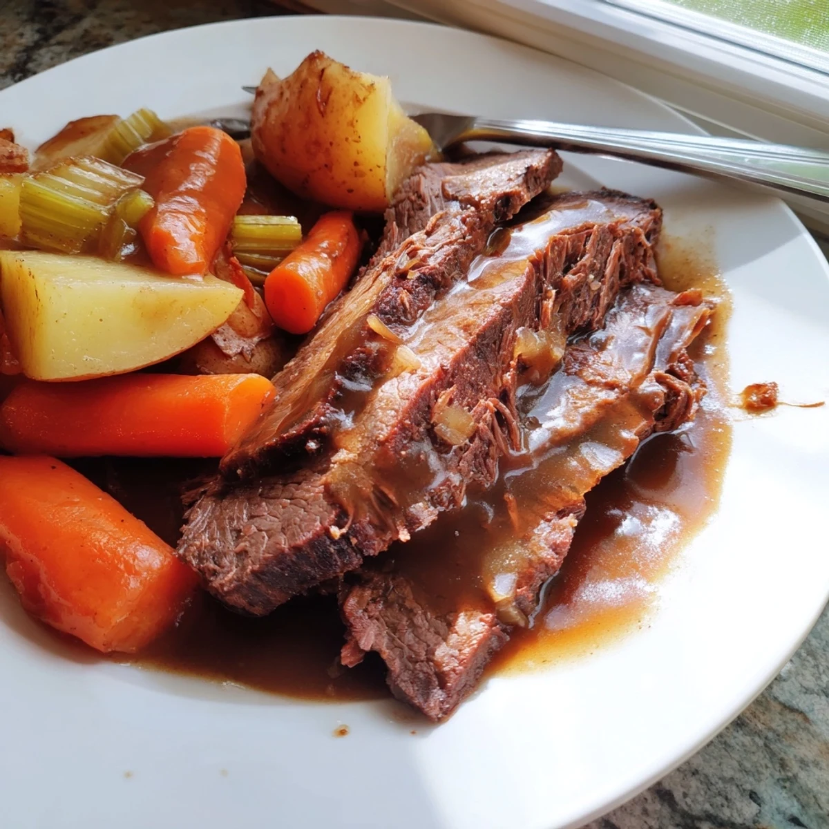 Fork-tender Southern style pot roast plate featuring melt-in-your-mouth beef surrounded by buttery roasted vegetables and savory sauce