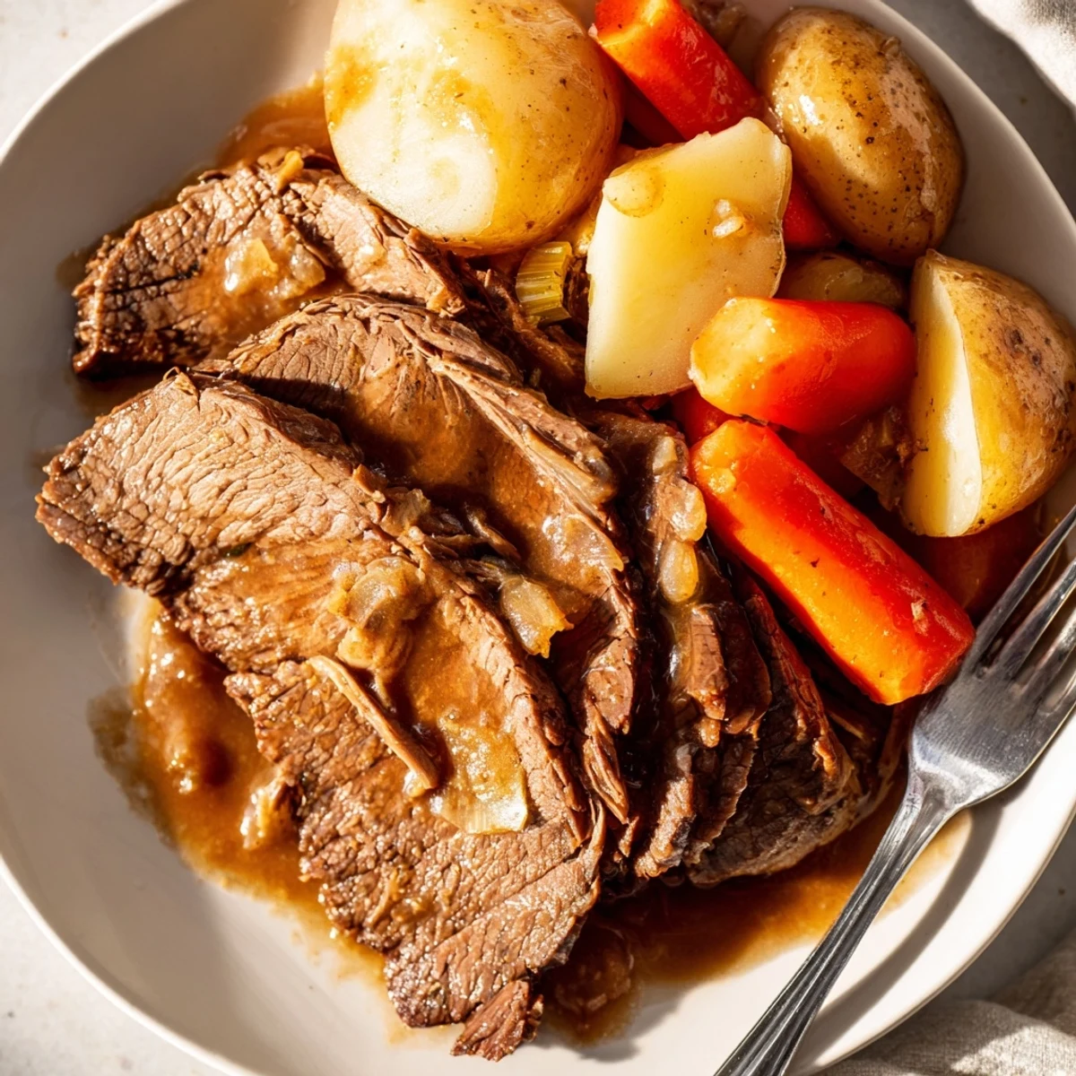Hearty Southern style pot roast served family style with chunky vegetables and thick beef gravy for a comforting meal