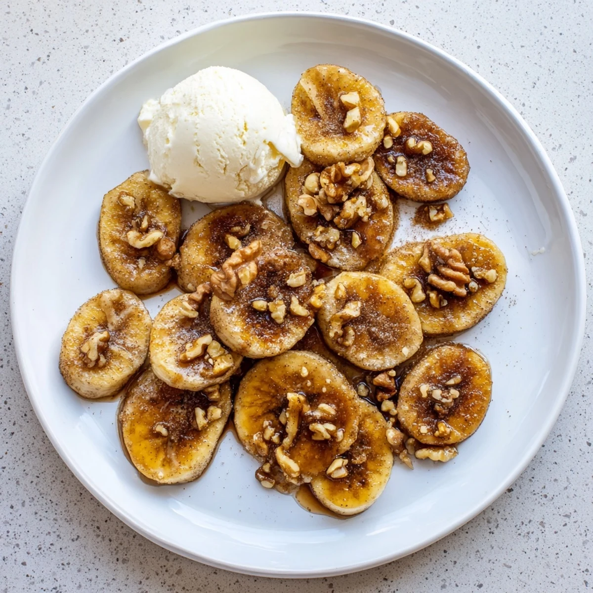 Golden pan fried cinnamon bananas sizzling in butter with caramelized edges and sweet cinnamon sugar coating