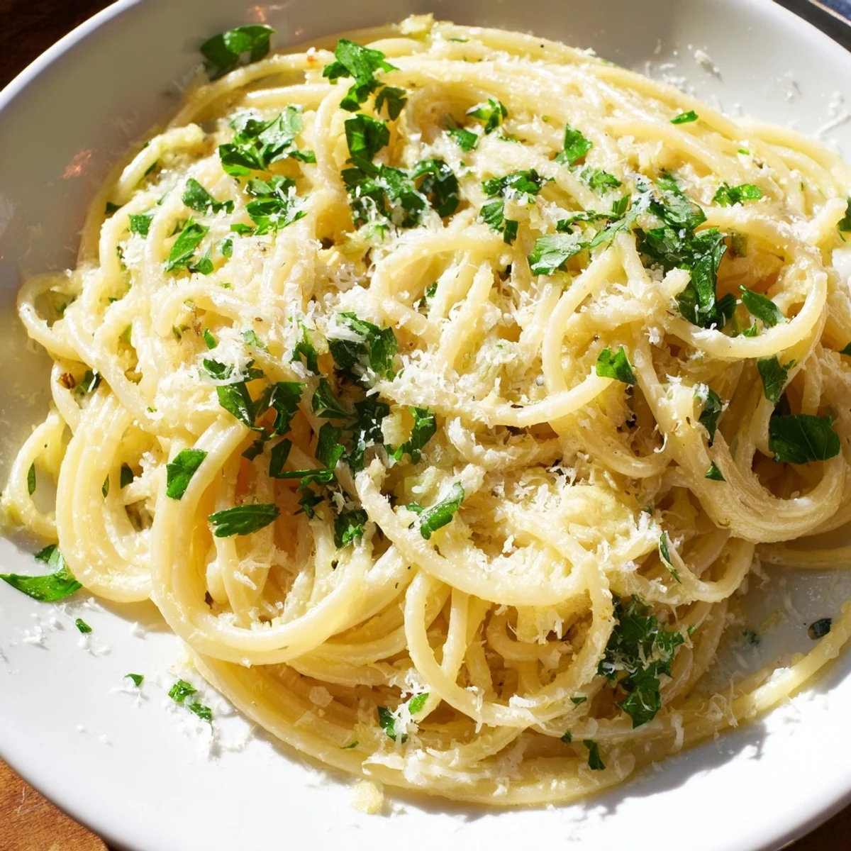 Steaming plate of one pot garlic butter pasta coated in creamy Parmesan sauce with fresh parsley garnish