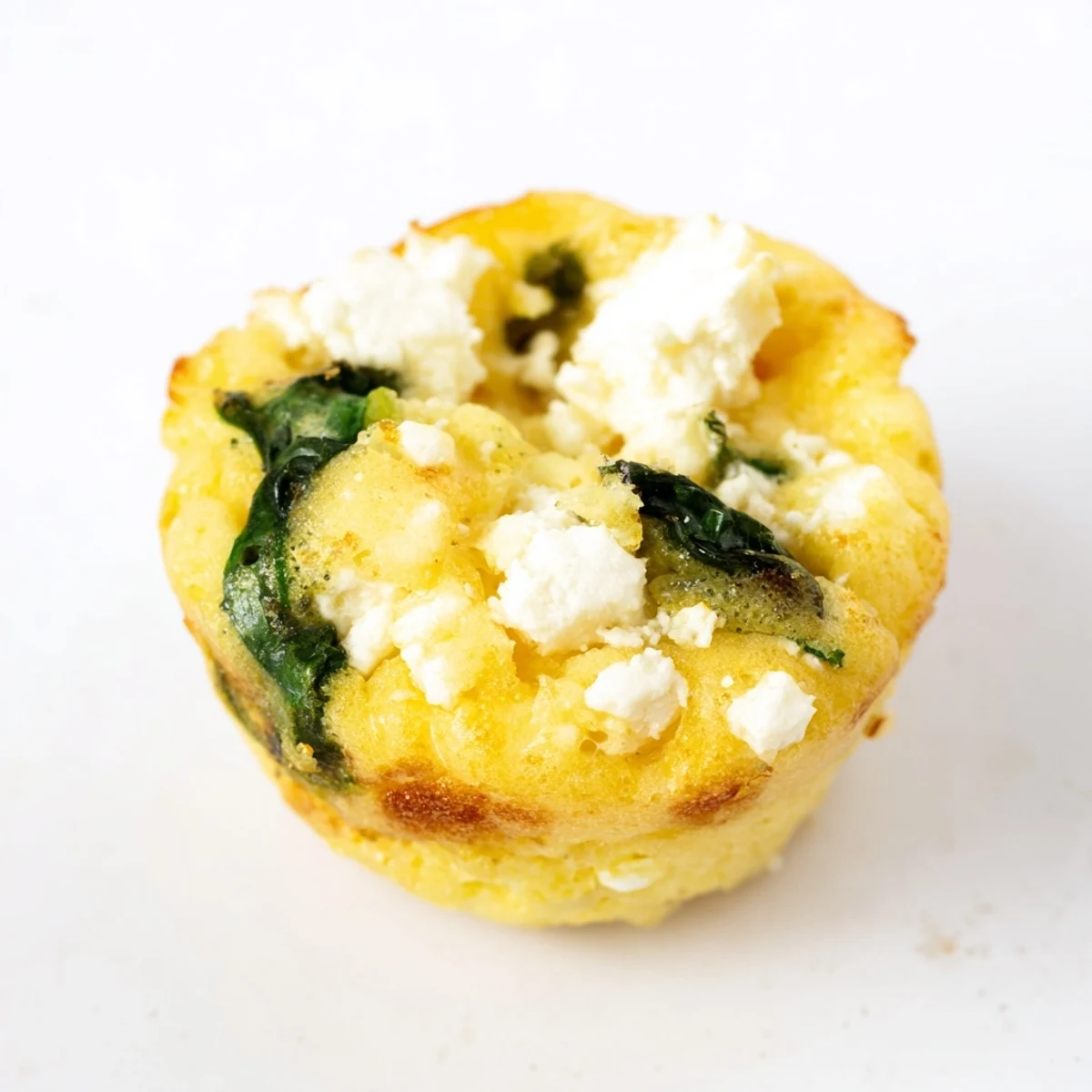 Golden baked egg muffins with spinach and feta ready for healthy breakfast