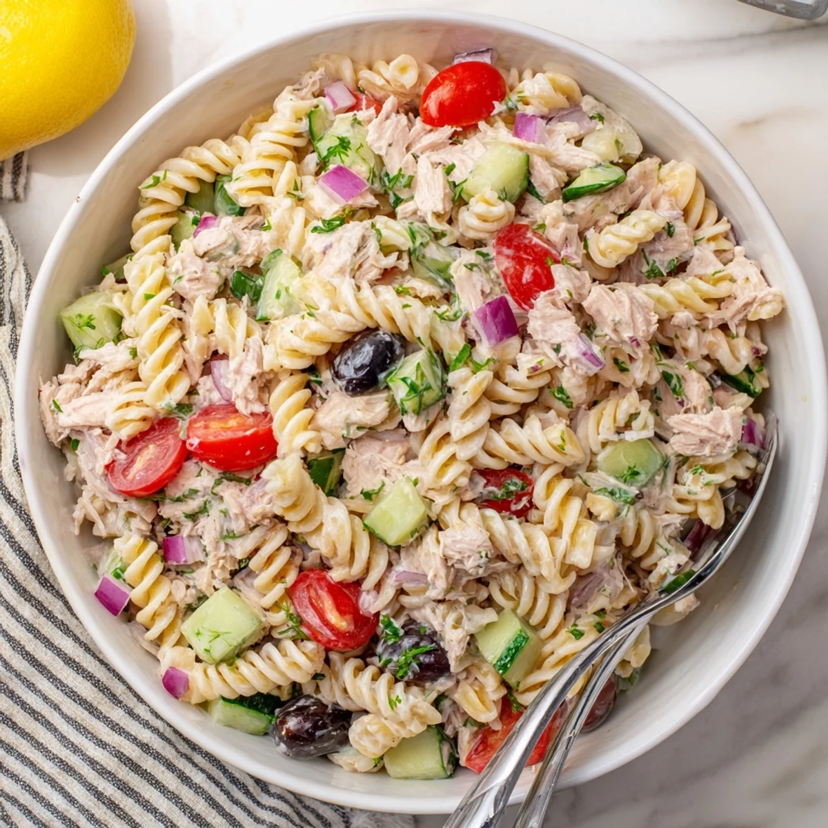 Creamy tuna pasta salad in a bowl with colorful vegetables and tender fusilli