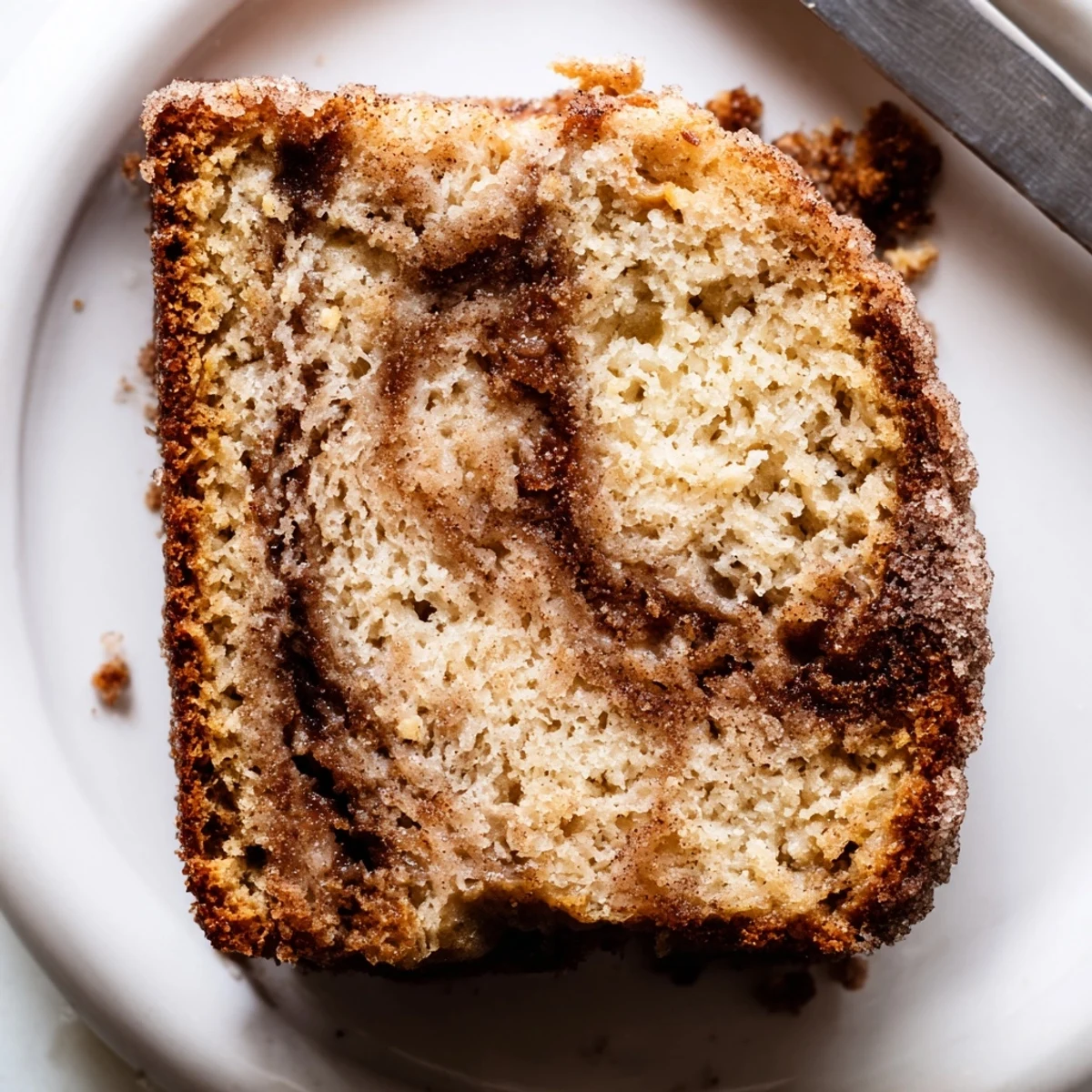 Thick slice of snickerdoodle banana bread served with melting butter on top