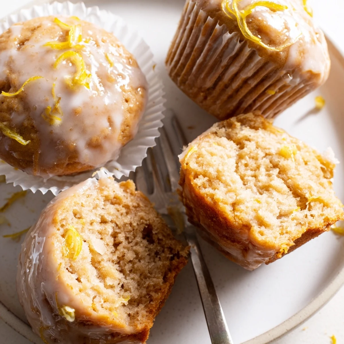 A plate of Glazed Lemon Ginger Muffins, zesty glaze, perfect with tea