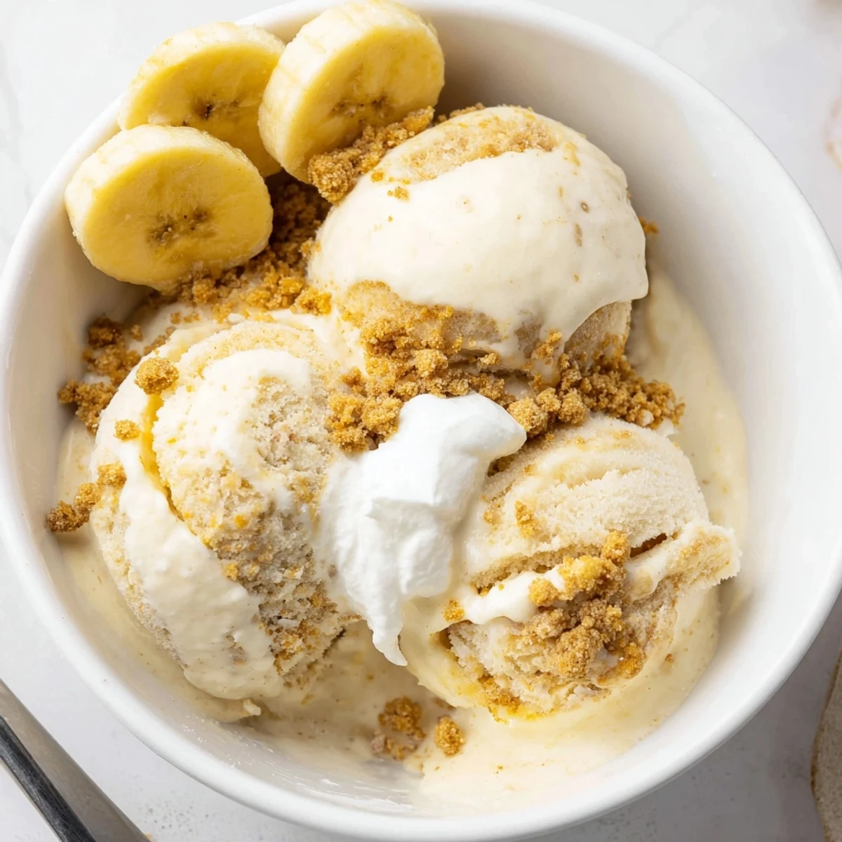 Ninja Creami Banana Cream Pie Ice Cream, glossy scoops with graham swirl.