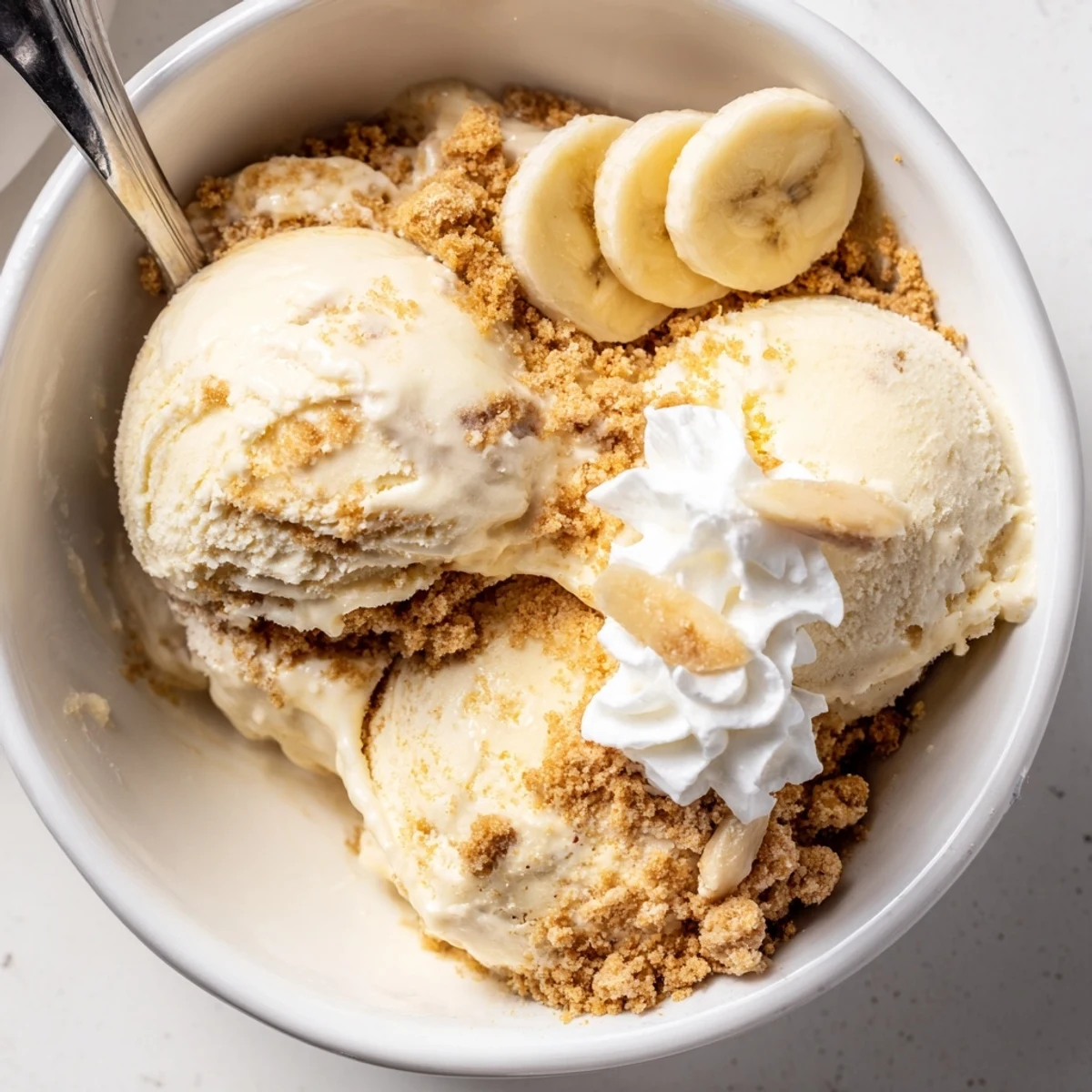 Homemade Ninja Creami Banana Cream Pie Ice Cream topped with whipped cream.