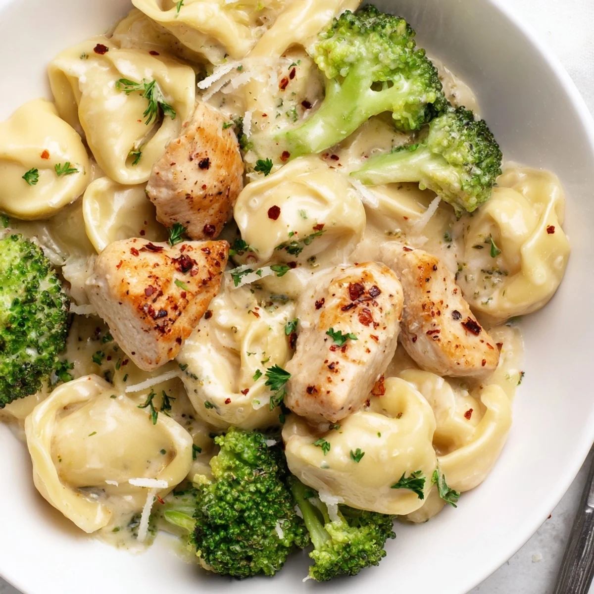Creamy Garlic Parmesan Tortellini Chicken Broccoli Recipe with golden chicken, tender tortellini, creamy sauce  