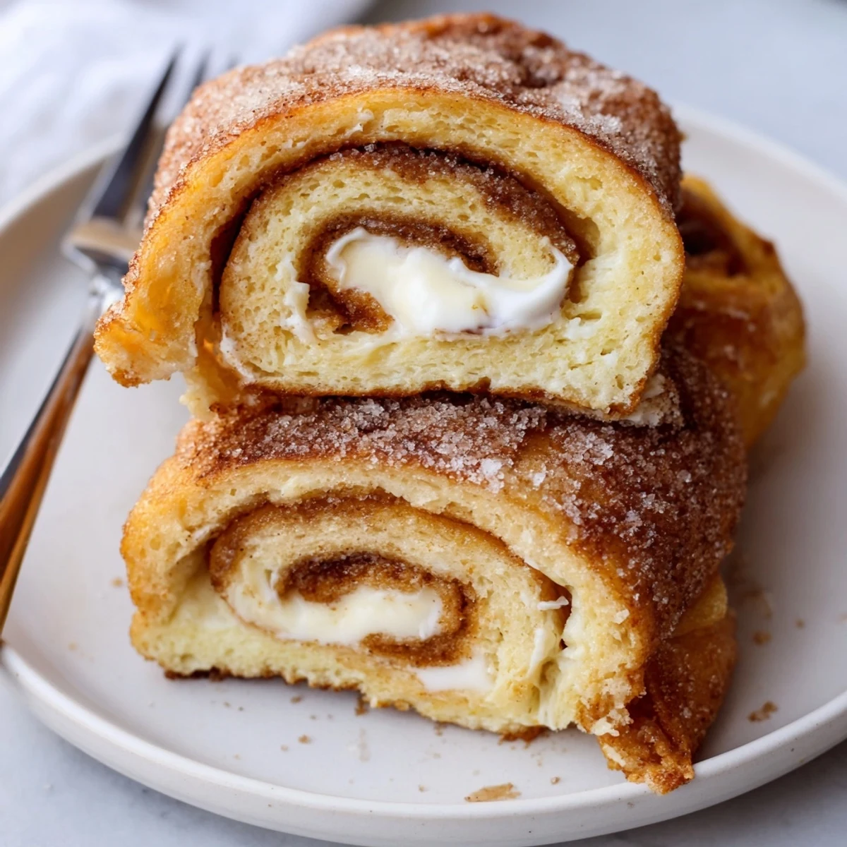 Cinnamon Roll French Toast Roll Ups: golden, cinnamon-sugar crust with creamy filling