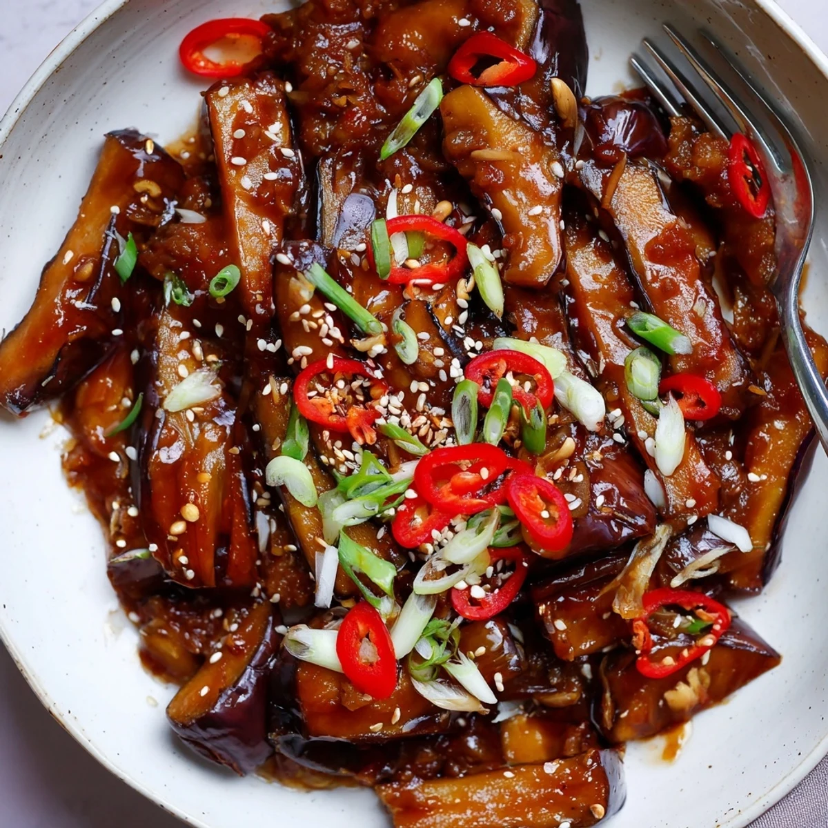 Serve Sichuan Style Braised Aubergines hot, silky eggplant batons in spicy sauce