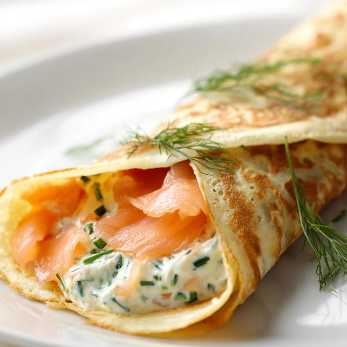Delicate rolled crepes wrapped around silky smoked salmon slices with garnish of lemon wedges and chives
