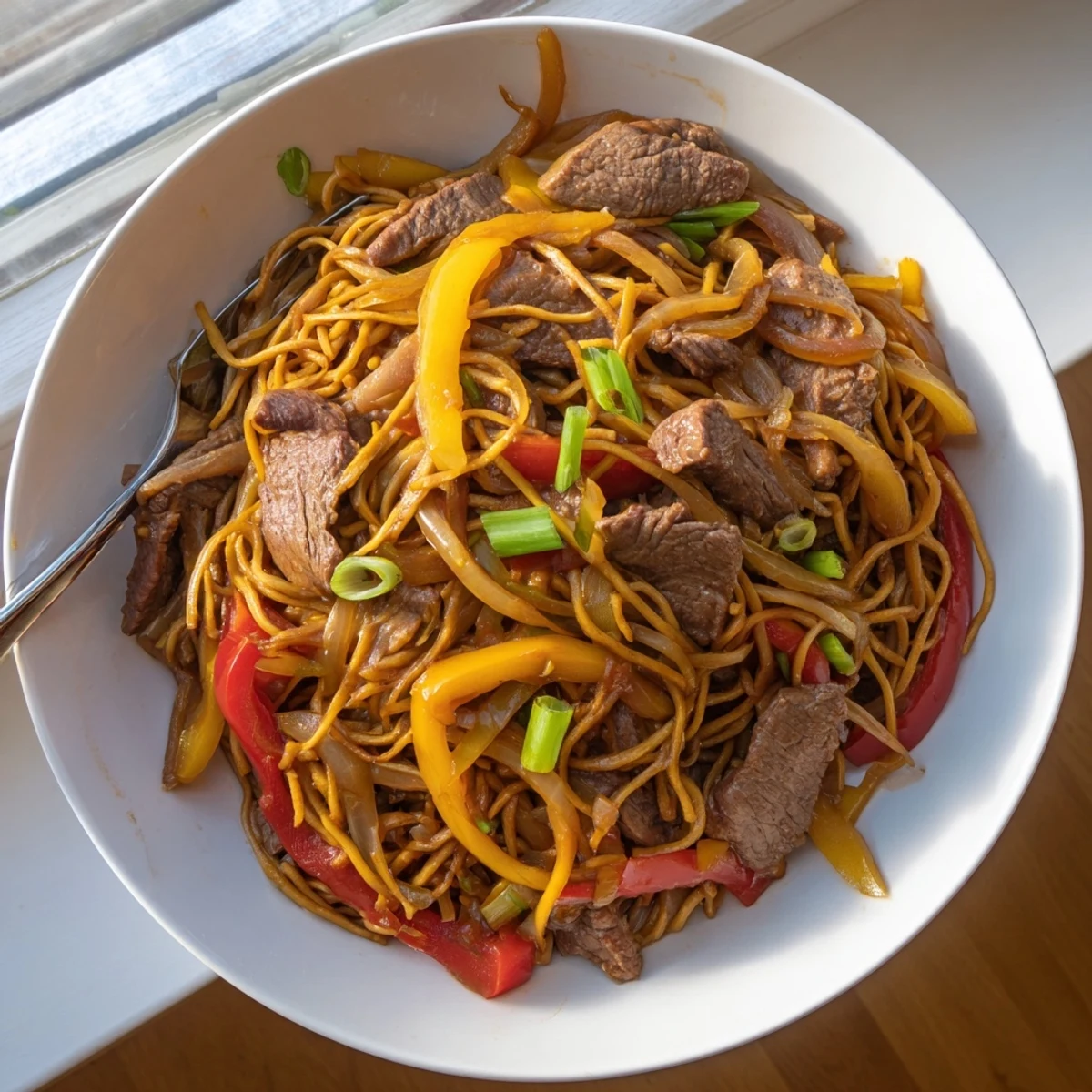 Vibrant plate of beef chow mein featuring tender meat slices and fresh vegetable medley