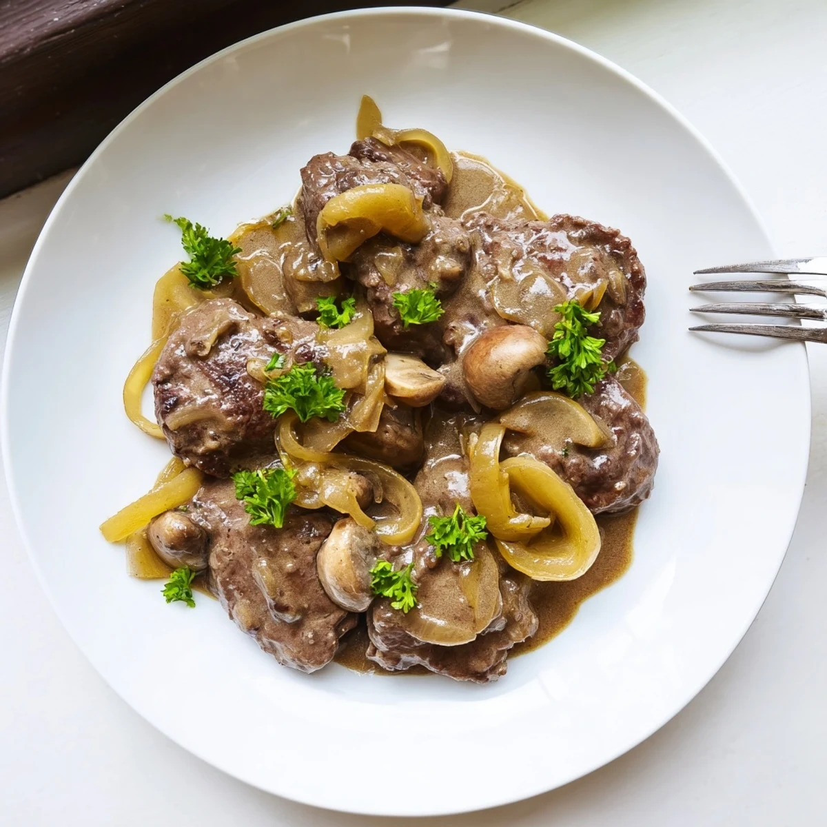 Tender beef cube steaks simmered in a savory brown gravy with sautéed onions and sliced mushrooms