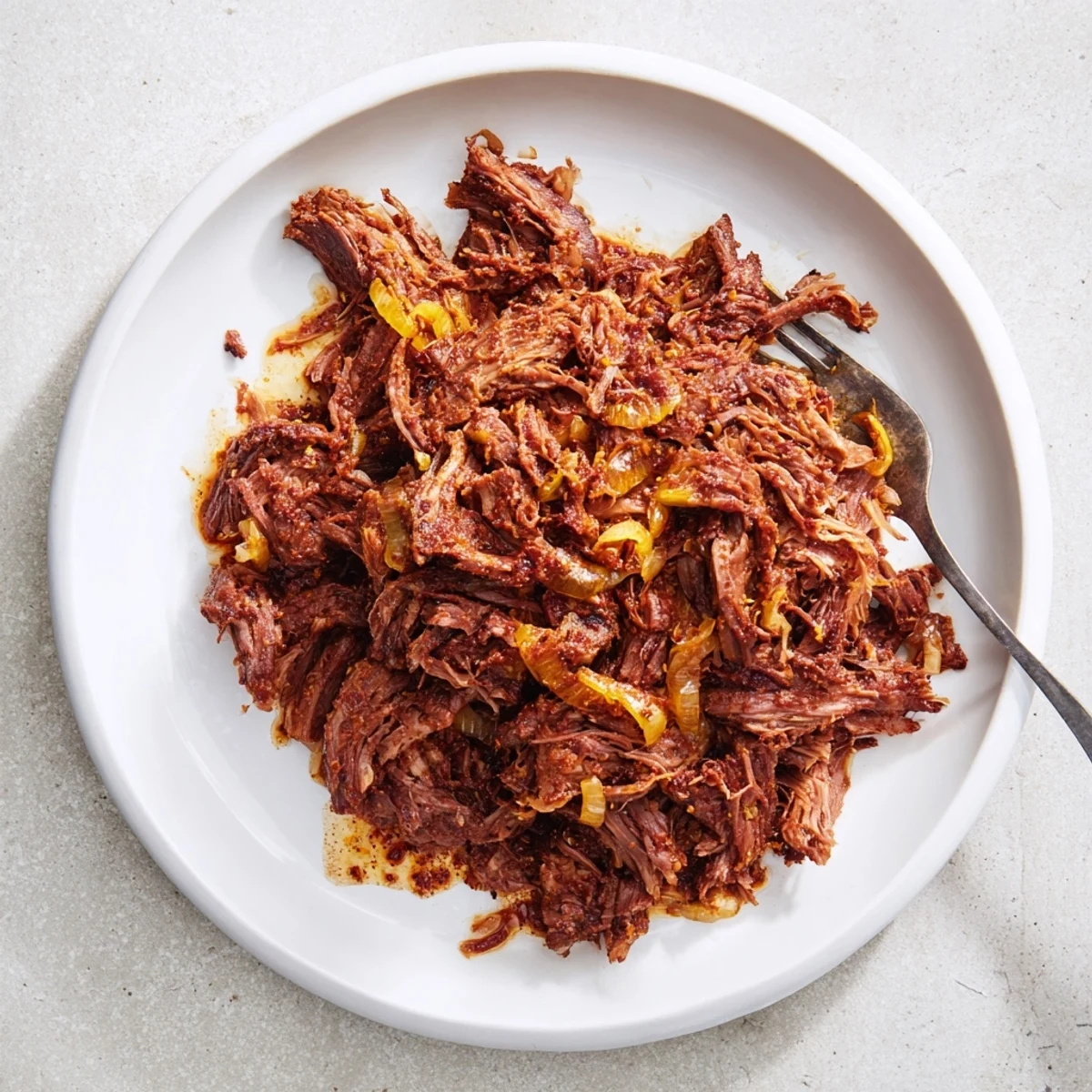 Authentic slow cooker beef barbacoa with rich chipotle sauce served in warm corn tortillas with fresh cilantro