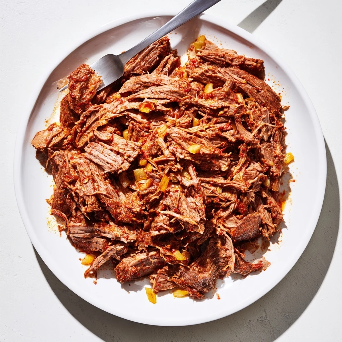Flavorful slow cooker beef barbacoa featuring perfectly shredded beef coated in aromatic spices and tangy adobo juices