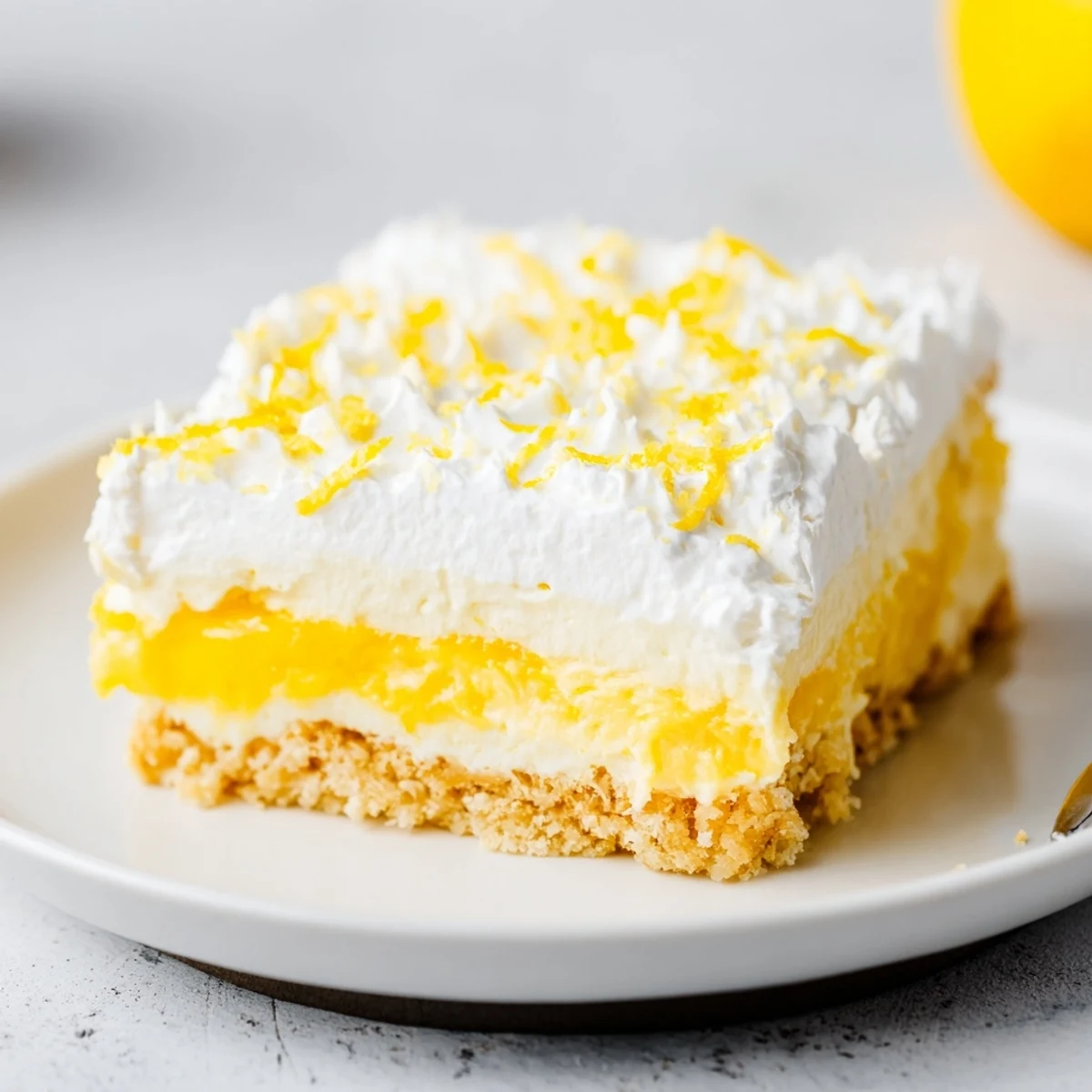 Chilled Lemon Lush Cake on a crisp cookie crust, zesty lemon aroma
