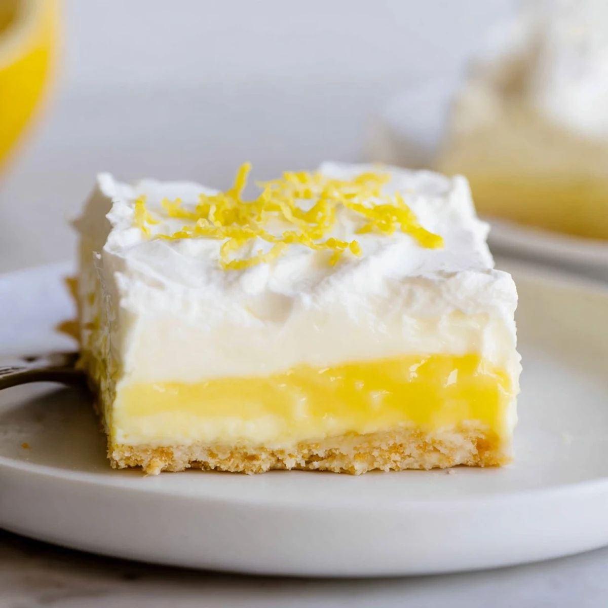 Lemon Lush Cake with creamy lemon layer and fluffy whipped topping