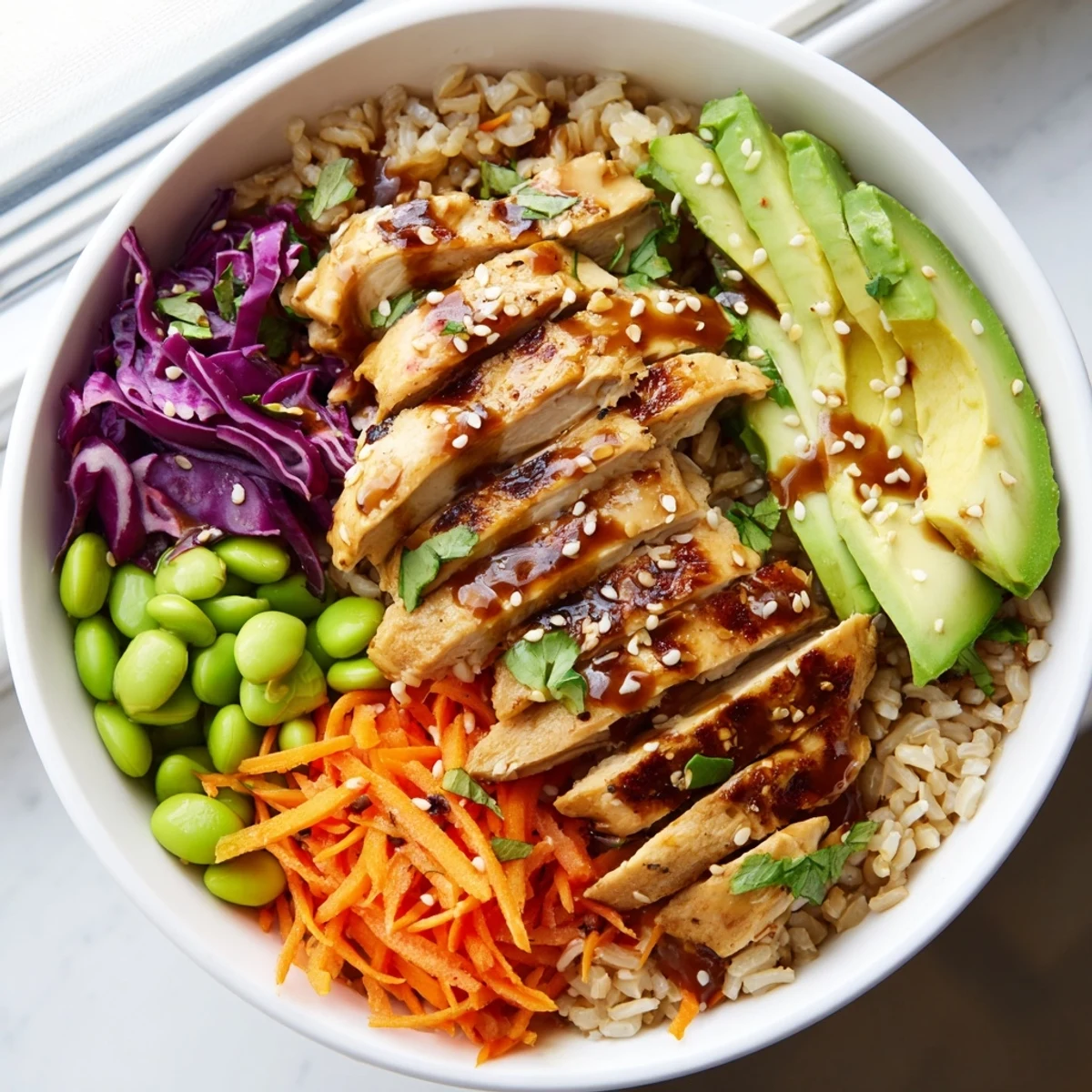 Asian Inspired Chicken Power Bowl with colorful vegetables drizzled in sesame-ginger dressing